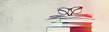 Buchstapel mit Brille
